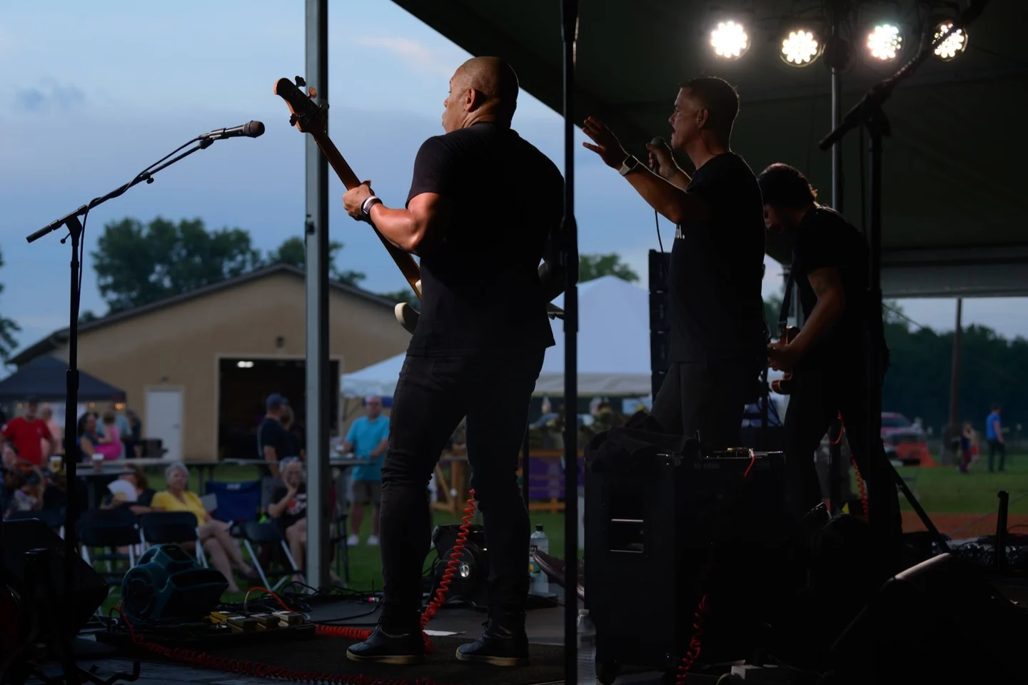 Band performing on stage at dusk