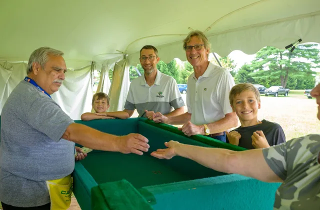 Families playing the festival dice game