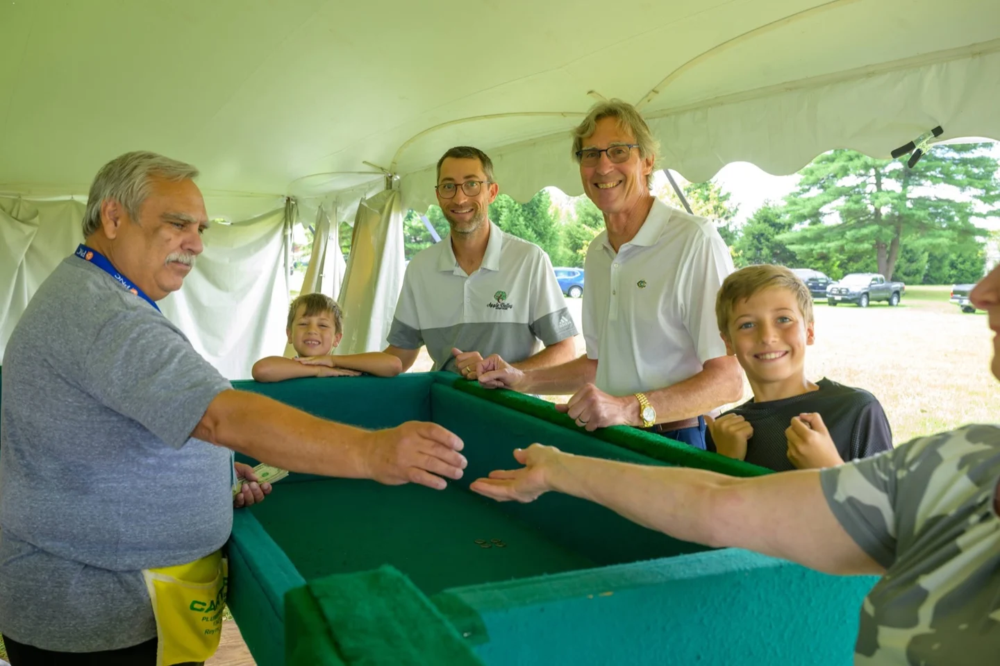 Families playing the festival dice game