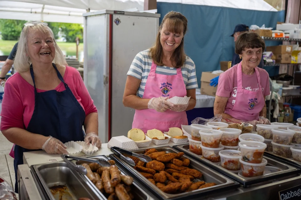Volunteers serving food in the food line