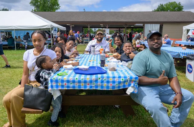 Family eating at a festival picnic table