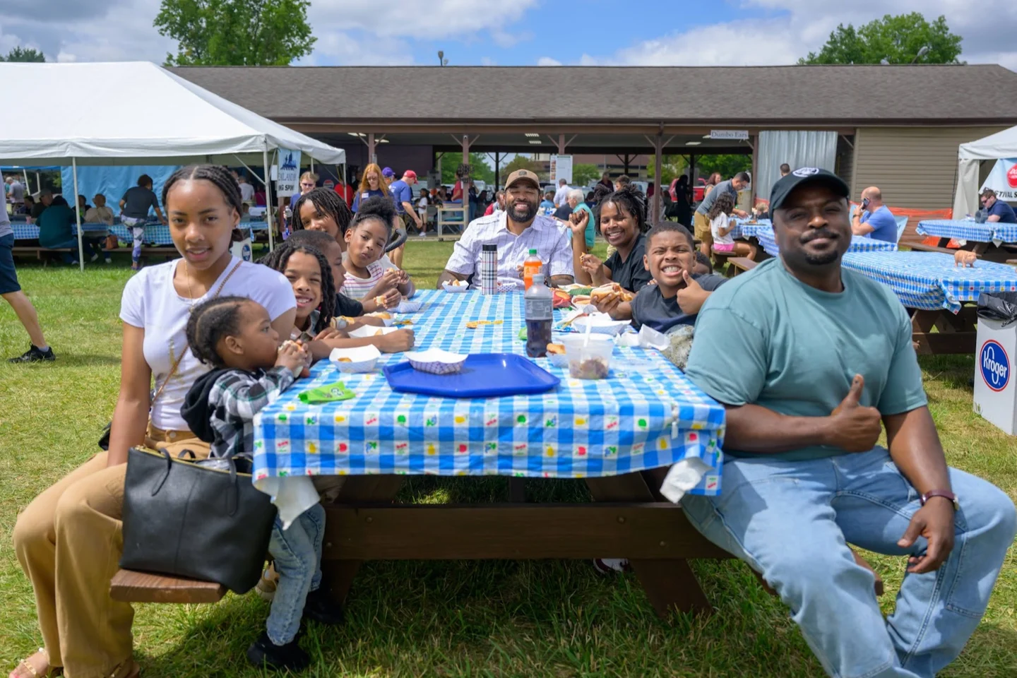 Family eating at a festival picnic table