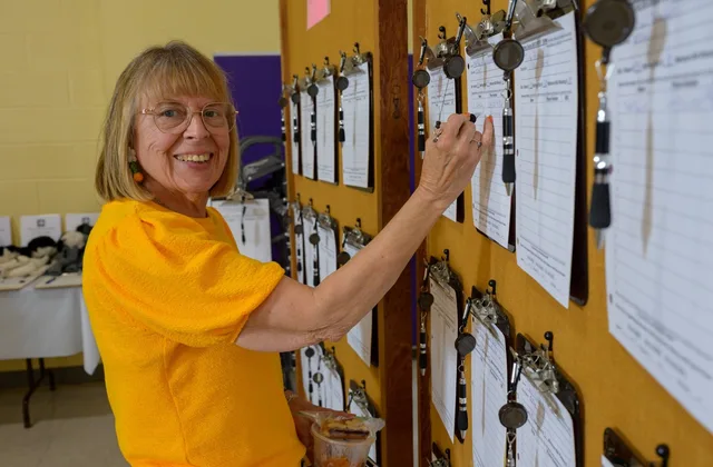 Festival guest bidding on silent auction items