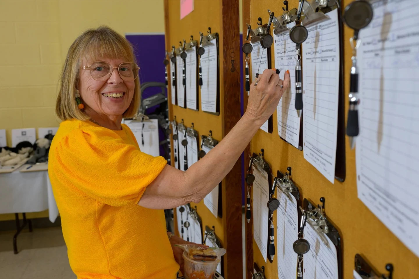 Festival guest bidding on silent auction items
